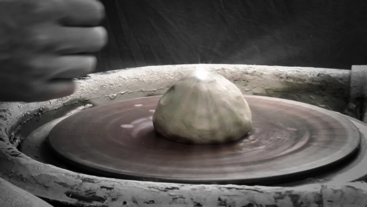 attaching clay to the pottery wheel